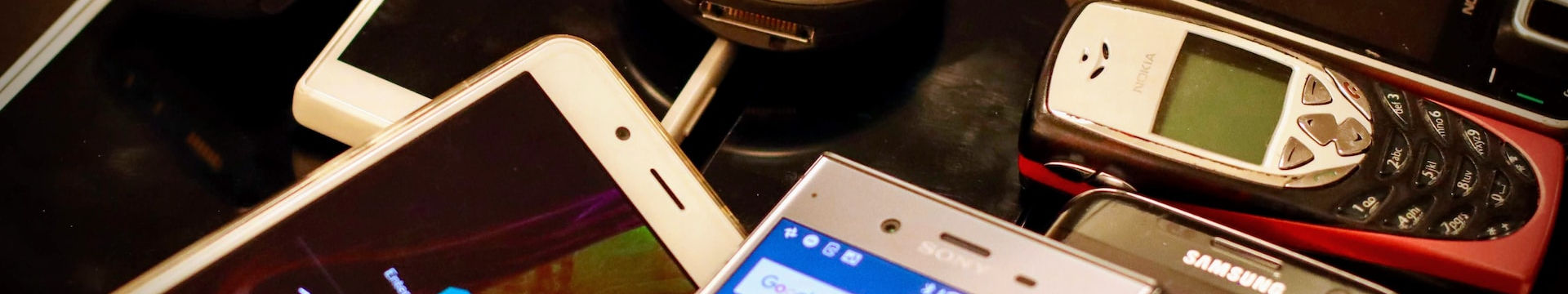 An image of a bunch of phones dumped on a table